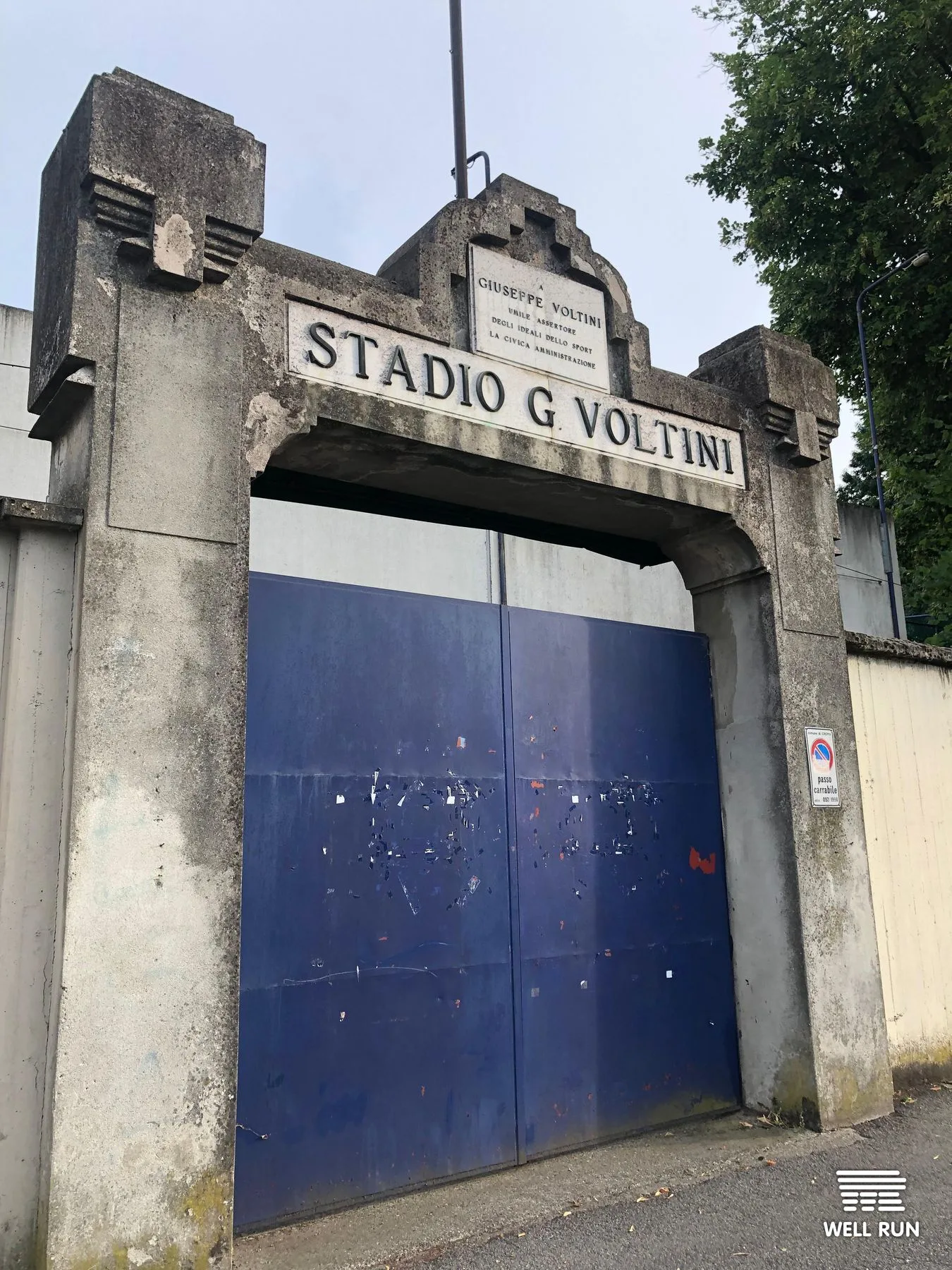 Stone archway entrance gate of Stadio G. Voltini football ground, Crema, Italy