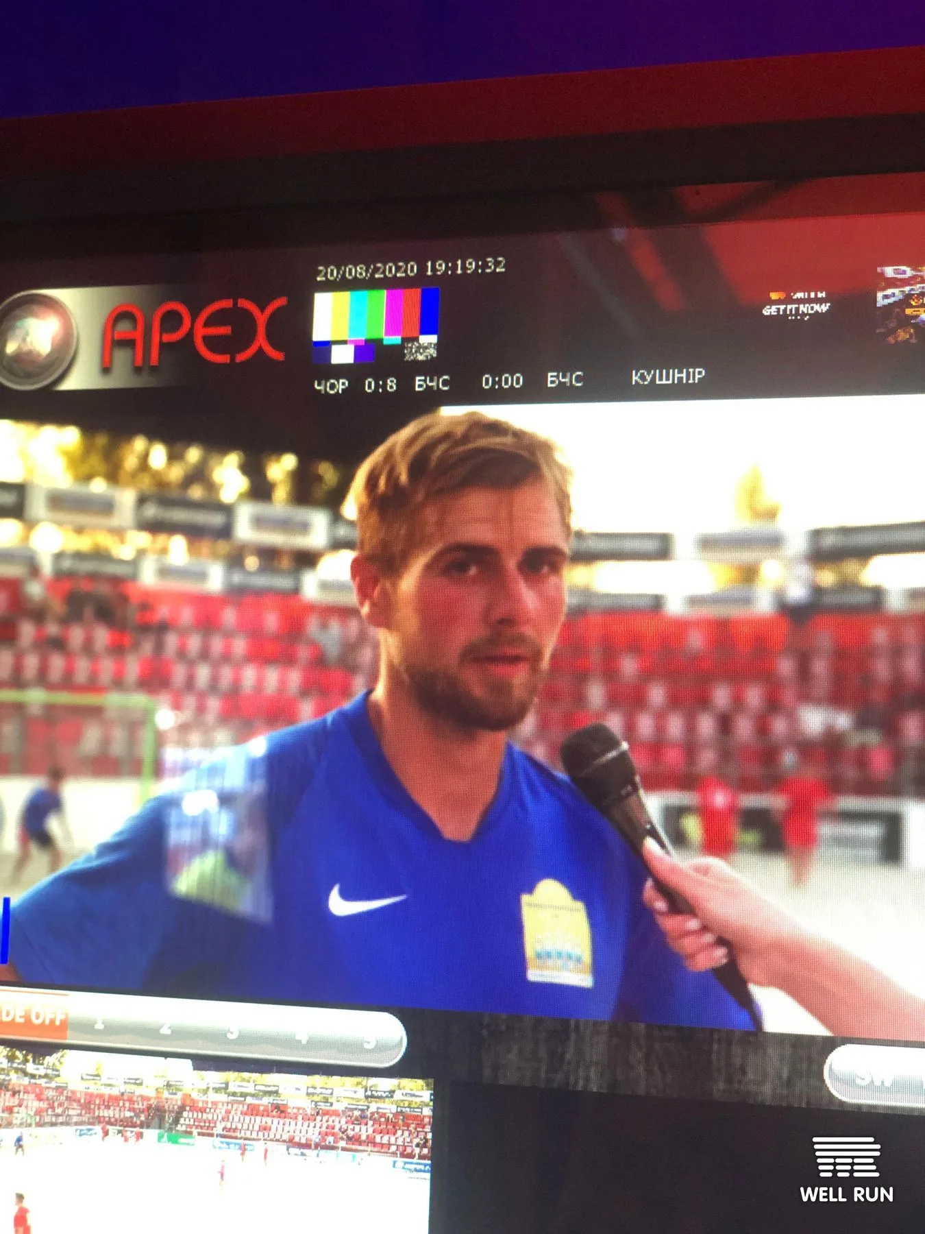 Beach soccer player in blue Nike kit gives pitchside interview during live TV broadcast at Mistosporty Kyiv