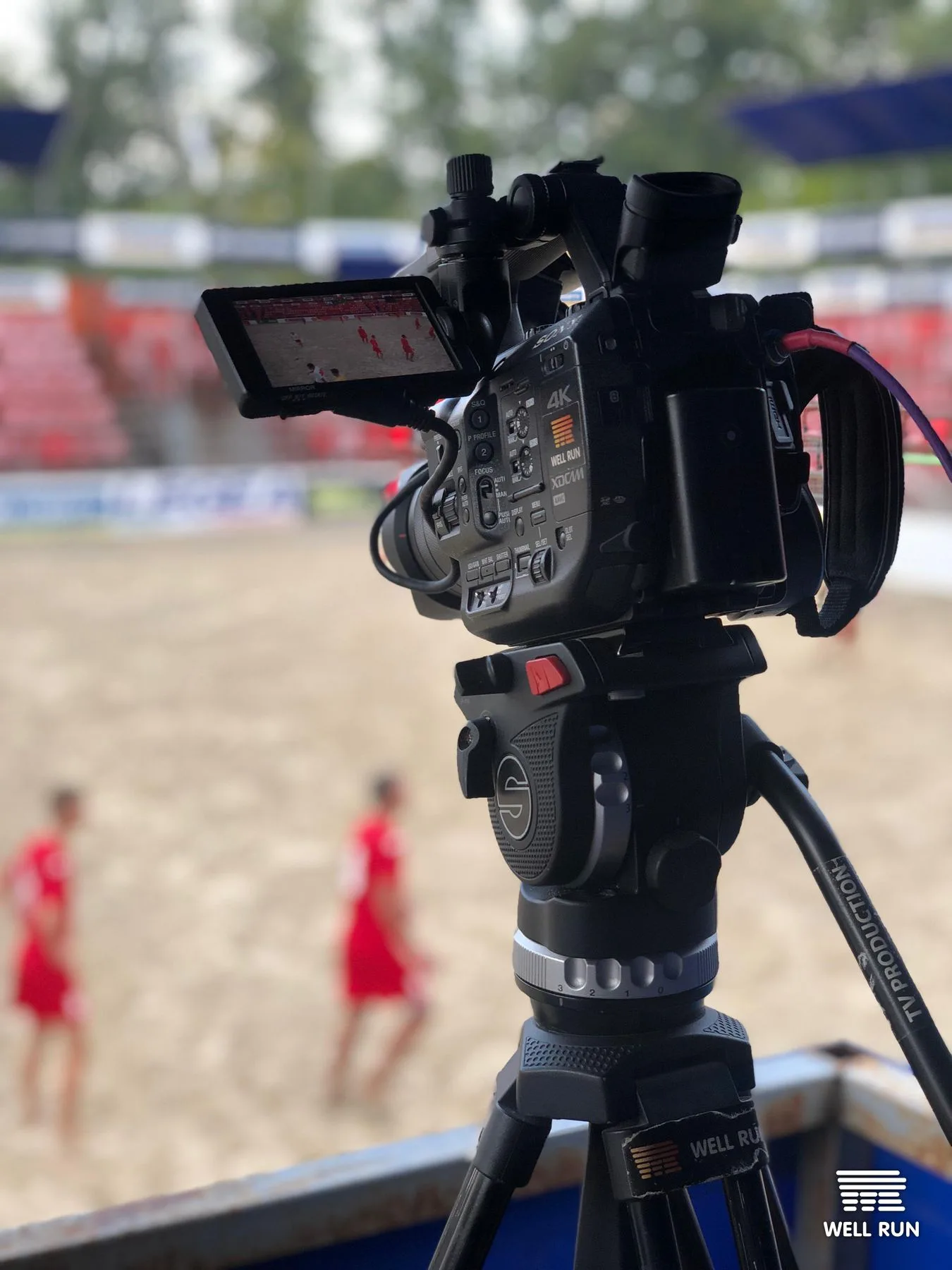 Sony XDCAM 4K camera on Well Run fluid-head tripod filming beach soccer players in red at Mistosporty Kyiv — frame 5