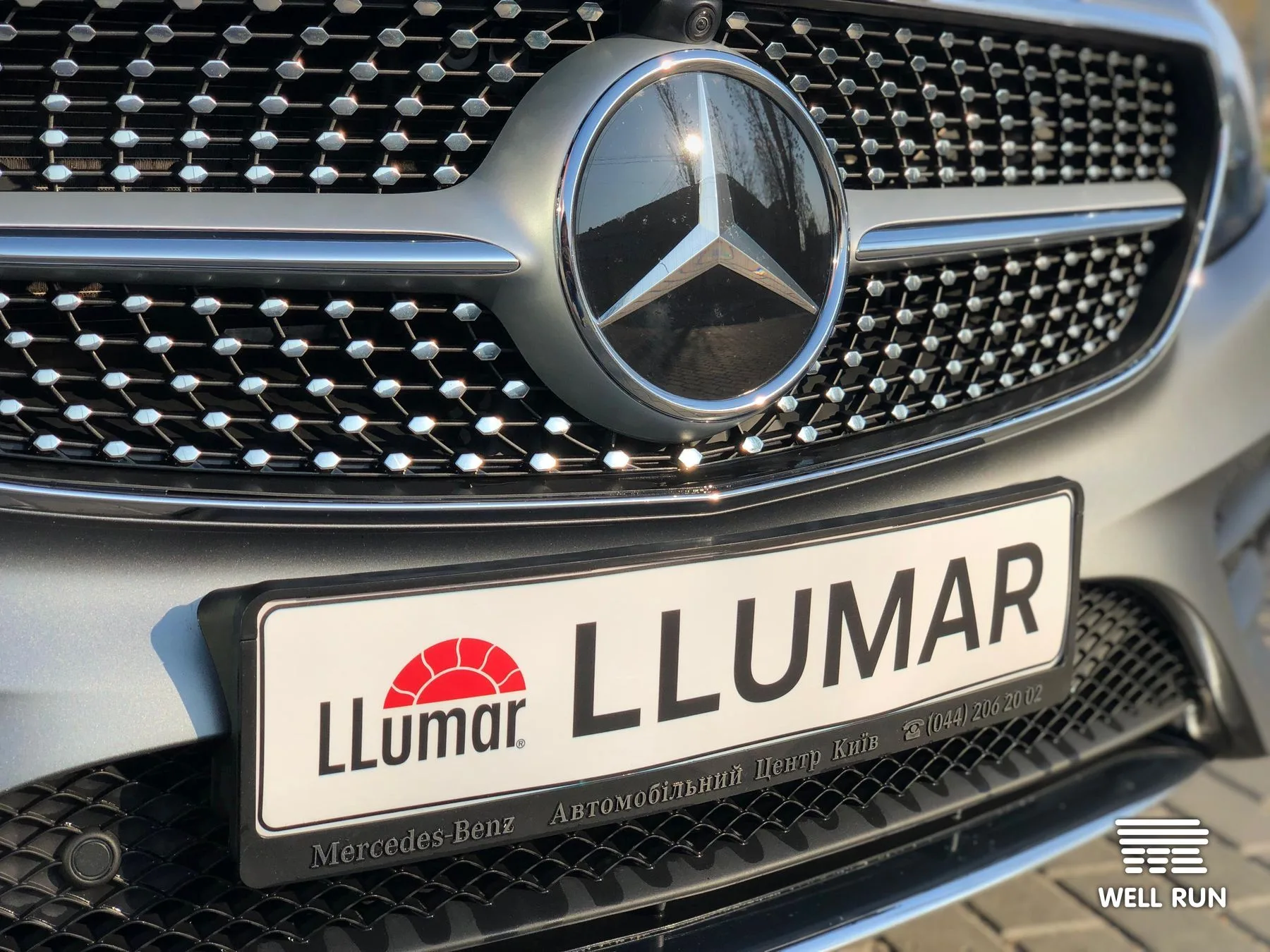 Close-up of Mercedes-Benz front grille with LLumar promotional licence plate, Kyiv