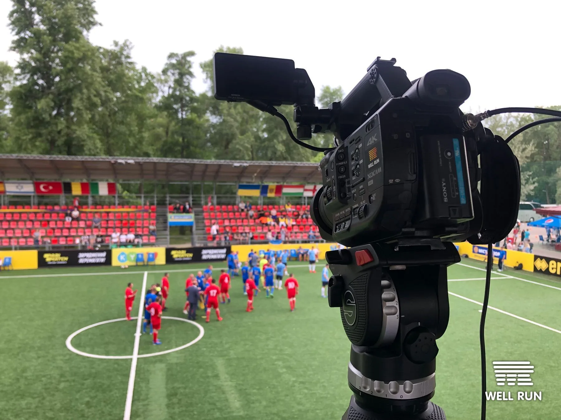 Sony 4K XDCAM broadcast camera on fluid-head tripod aimed at Klitschko Cup 2019 football pitch, Kyiv