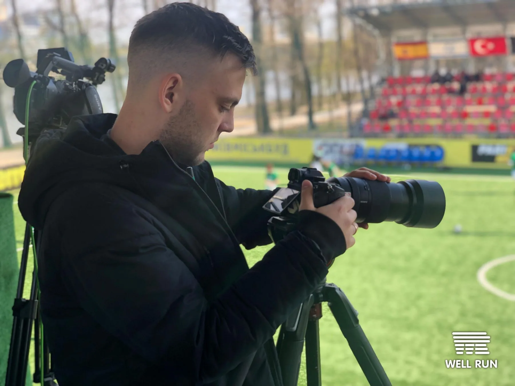 Kostiantyn Moseichenko holds a videocamera on tripod at Klitschko Cup 2019 sideline, Kyiv