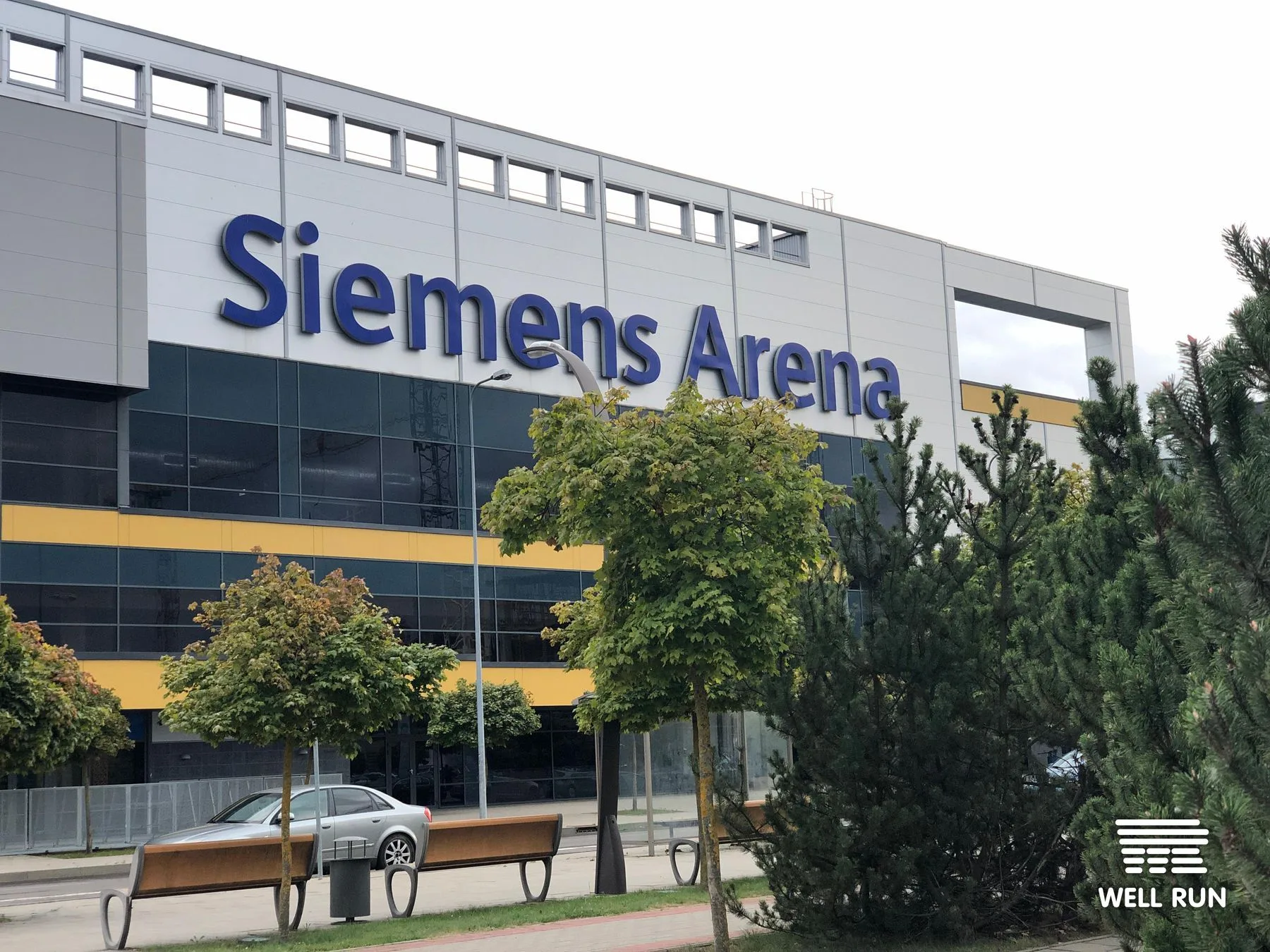 Exterior facade of Siemens Arena in Vilnius showing large blue venue signage — frame 1