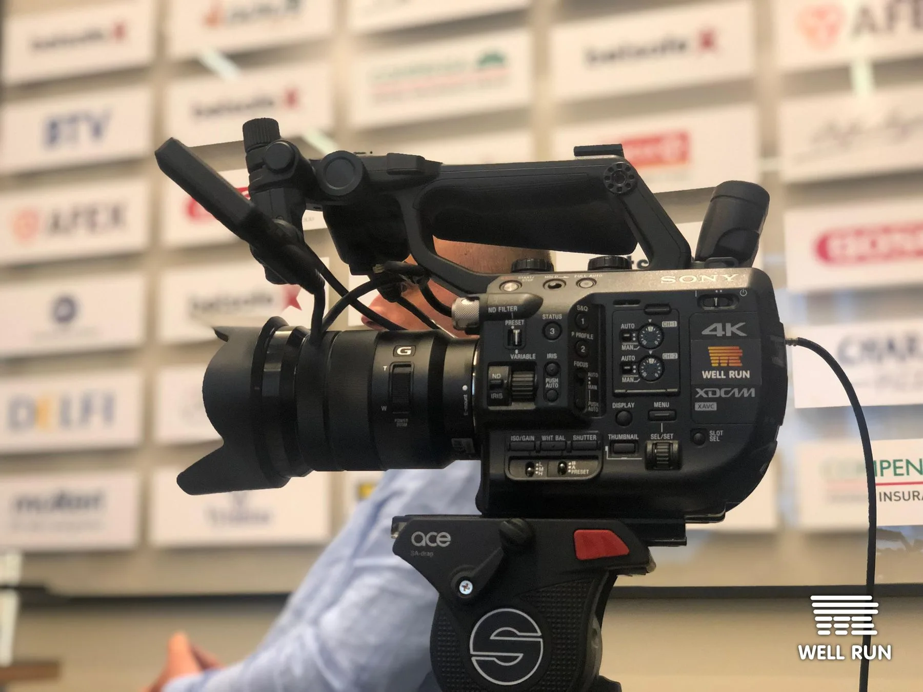 Sony 4K XDCAM camera on Sachtler ace tripod head at LKL sponsor backdrop, Vilnius