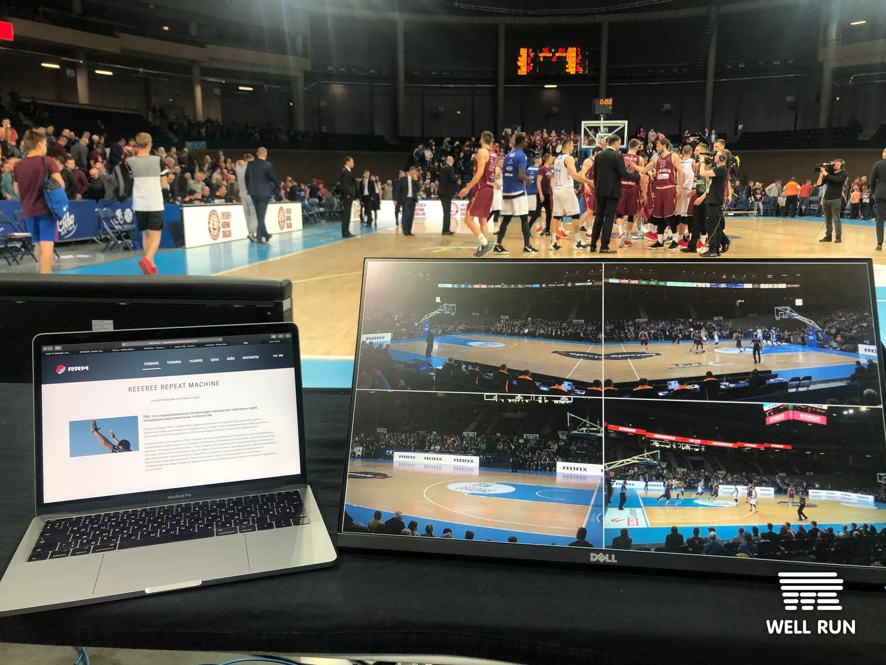 RRM multi-angle replay monitor showing live LKL basketball game courtside in Vilnius arena